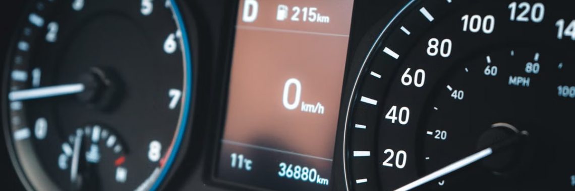Detailed view of a car dashboard featuring speedometer and digital display showing 0 km/h.